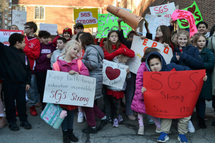 A group of K-8 grade students hold up signs at a rally to save St. Gabriel’s School in Riverdale, Bronx on Tuesday, Feb. 14, 2023. The school is set to merge with St. Margaret of Cortona in North Riverdale.
