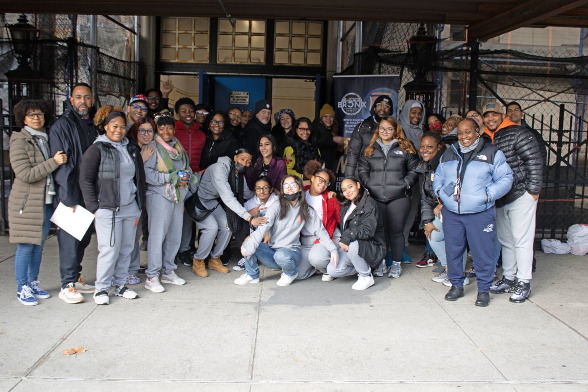 Principal Jose Zayas of Bronx Aerospace High School, which is part of the Evander Childs Educational Campus, school staff members, Moonshot Nights members, and volunteers distribute food and goods during the Moonshot Nights Community Food Distribution on Saturday, Dec. 9, 2023.