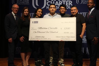 Bronx teenager Matthew Carillo holds his $1,500 college scholarship check during the celebration on Monday.