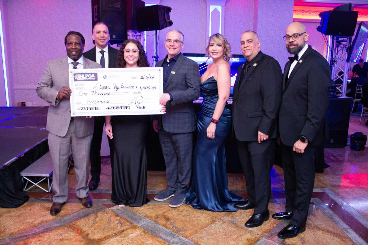 Honoree Alyssa Vega Escudero holds her Merrick Financial Scholarship in a photo National Latino Peace Officers Association (NLPOA Bronx Chapter) board members.
