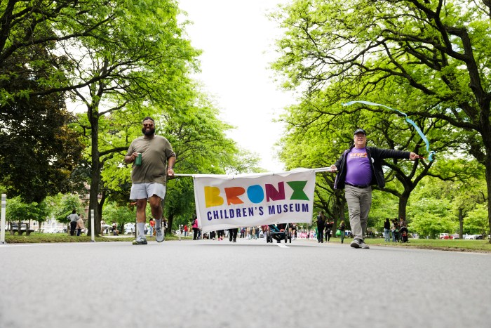 People from the Bronx Children's Museum travel Mosholu Parkway during the annual Bronx Week parade on Sunday, May 19, 2024.