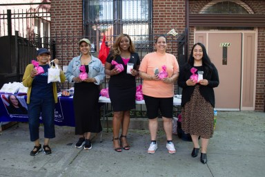 Vernice Nina Etienne, Suraiyah Ortiz of Planned Parenthood, New York City councilmember Farah N. Louis, The C.O.R.E. Family Enrichment Center & Bronx River Houses Resident President Norma Saunders, and councilmember Amanda Farias in a group photo in the front of the CORE FEC office holding bags filled with menstrual products. Photo Jewel Webber
