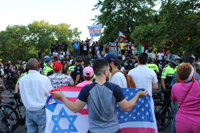 People demonstrate outside former President Donald Trump's campaign rally in the Bronx's Crotona Park on Thursday, May 23, 2024.