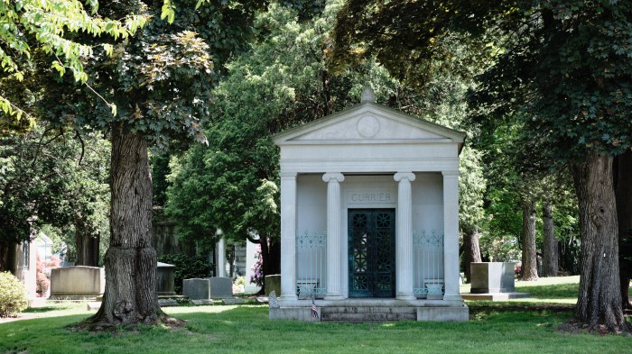 Woodlawn serves as both a cemetery and a arboretum with over 500 species of trees and many Mausoleums, including this one with a flag planted in front of it on May 20, 2024.