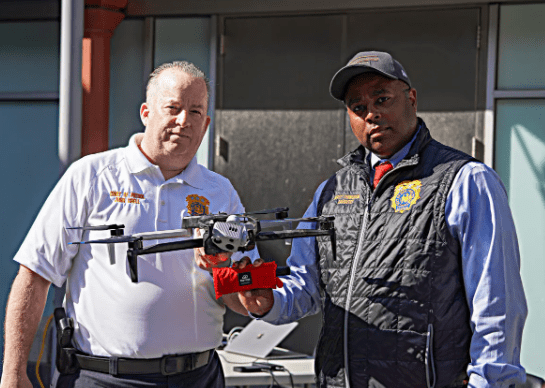 NYPD Chief Patrol John Chell, left, and NYPD Deputy Commissioner Kaz Daughtry, right, with a police drone. 