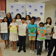 Winning students from the Throggs Neck Community Action Partnership's annual poster contest present their pieces. Photo courtesy Dawn Insanalli