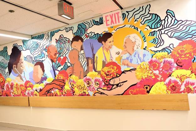 <span class="image-credit">The new mural at NYC Health + Hospitals/North Central Bronx, Waves of Healing, features images of hospital staff caring for the community. Photo courtesy NYC Health + Hospitals
